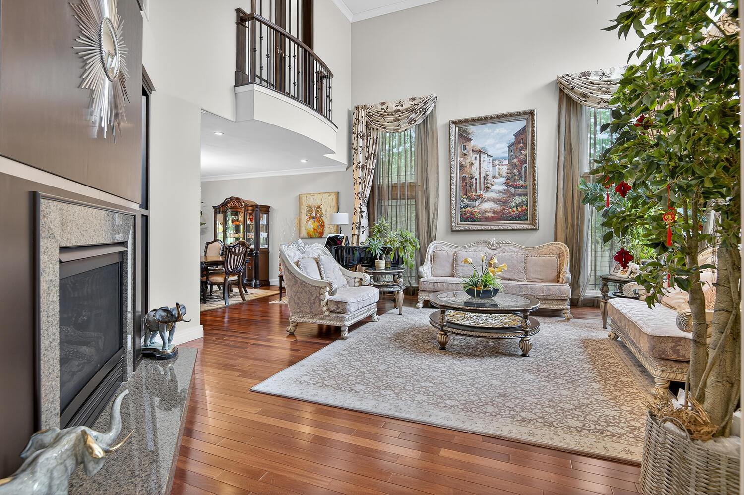 25 Holiday Pond Road Jericho, NY 11753 - Photo 1 of 1 Living room with crown molding, wood-type flooring, a premium fireplace, and a high ceiling