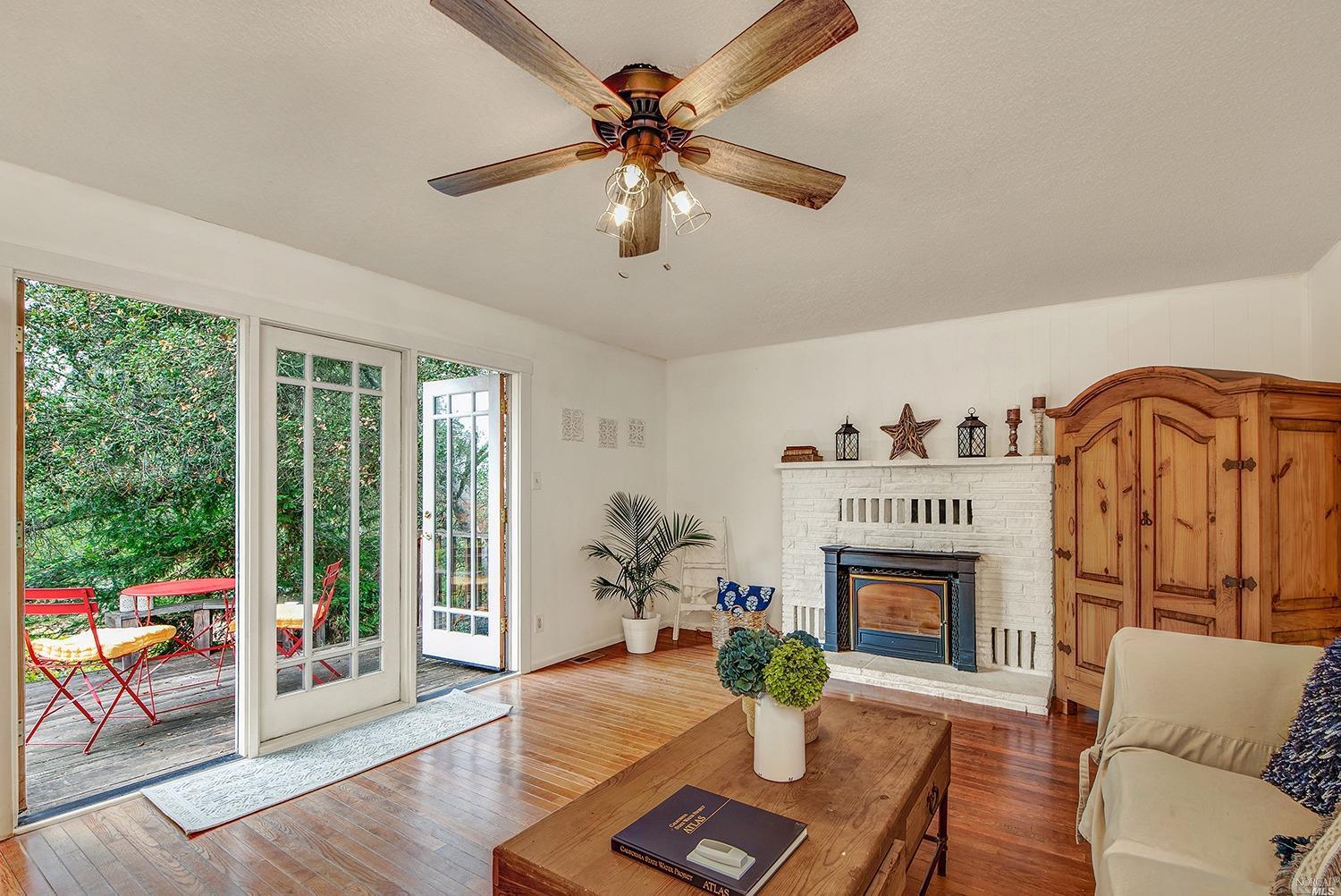 12989 Occidental Road Sebastopol, CA 95472 - Photo 1 of 1 a living room with furniture and a fireplace