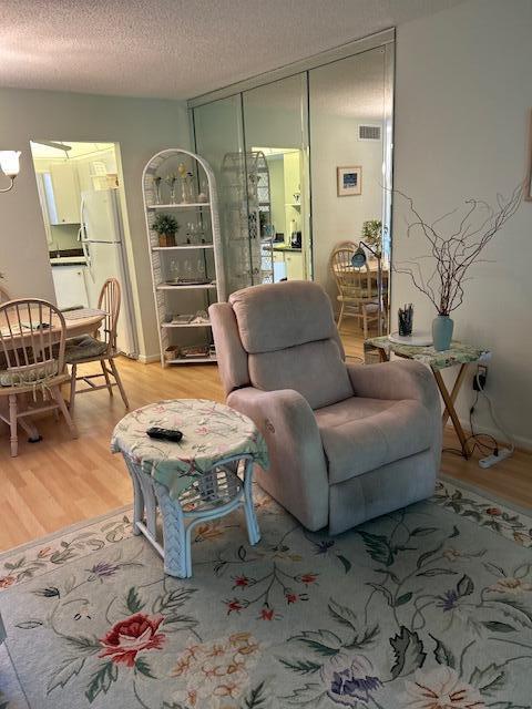 1955 Southwest Palm City Road, Unit H Stuart, FL 34994 - Photo 9 of 22 a living room with furniture and wooden floor