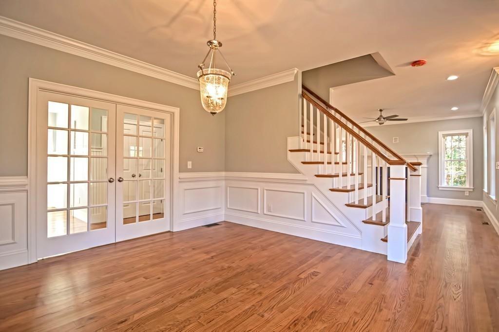 115 High Street Medfield, MA 02052 - Photo 11 of 42 a view of an entryway with wooden floor and chandelier