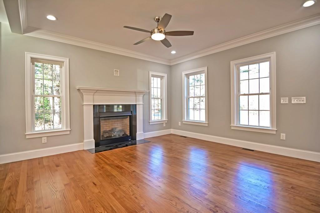 115 High Street Medfield, MA 02052 - Photo 14 of 42 a view of an empty room with wooden floor fireplace and a window