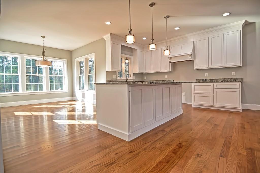 115 High Street Medfield, MA 02052 - Photo 16 of 42 a large kitchen with granite countertop a stove top oven a sink a counter space and wooden floor