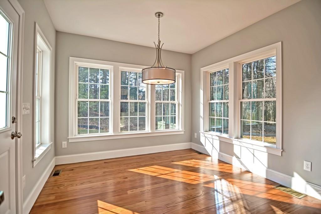115 High Street Medfield, MA 02052 - Photo 20 of 42 a view of an empty room with a window and wooden floor