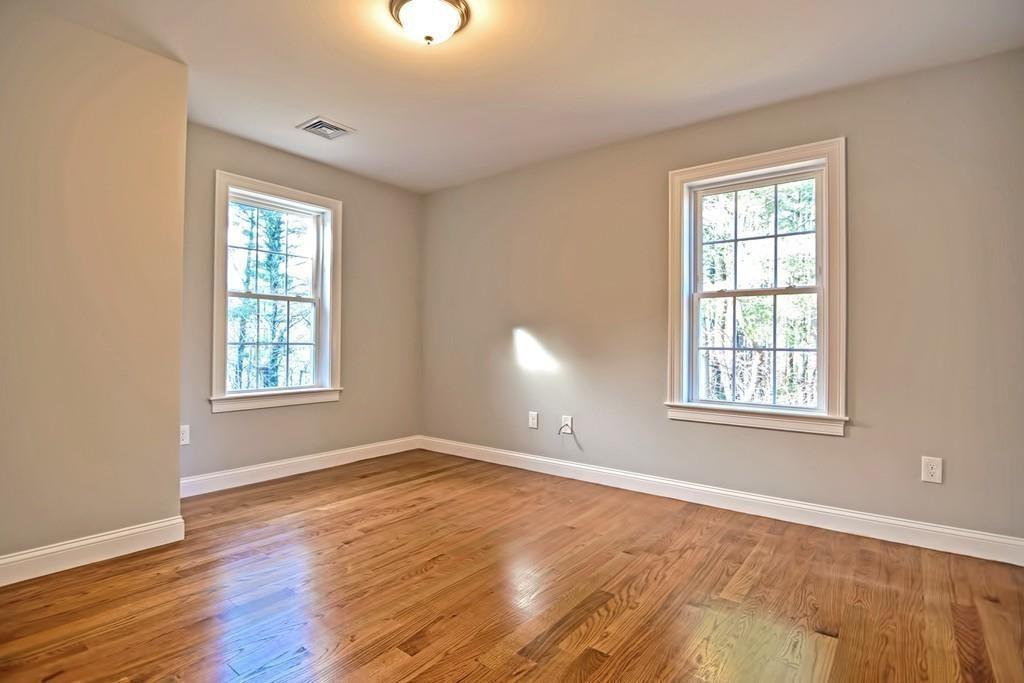 115 High Street Medfield, MA 02052 - Photo 28 of 42 a view of an empty room with wooden floor and a window