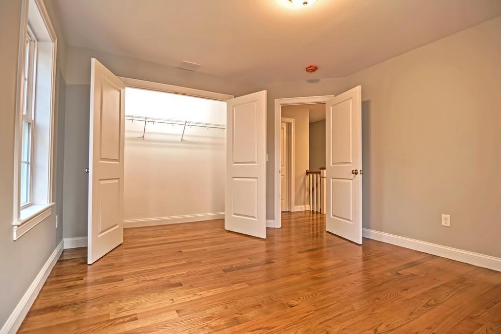 115 High Street Medfield, MA 02052 - Photo 30 of 42 an empty room with wooden floor and windows