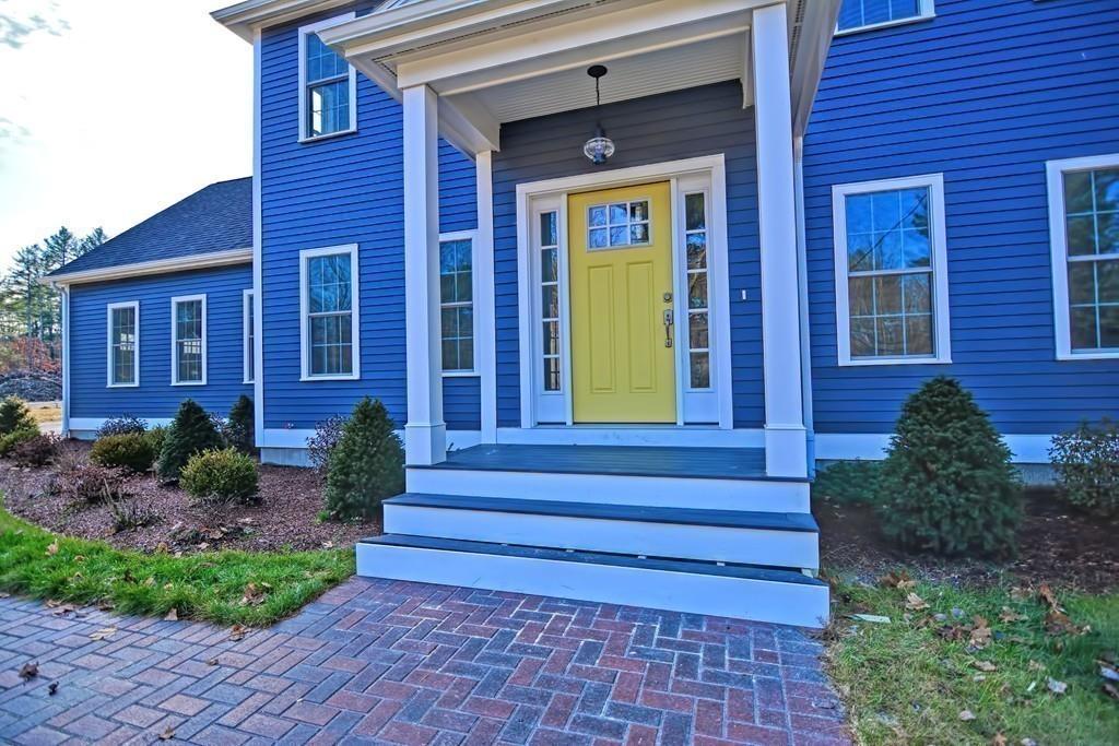 115 High Street Medfield, MA 02052 - Photo 3 of 42 a view of a brick house with a large window and potted plants