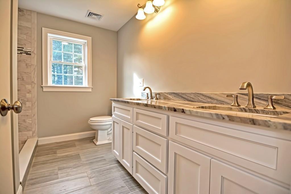 115 High Street Medfield, MA 02052 - Photo 35 of 42 a bathroom with a granite countertop sink and a toilet