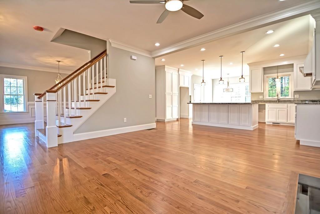 115 High Street Medfield, MA 02052 - Photo 4 of 42 a view of an empty room and kitchen view with wooden floor