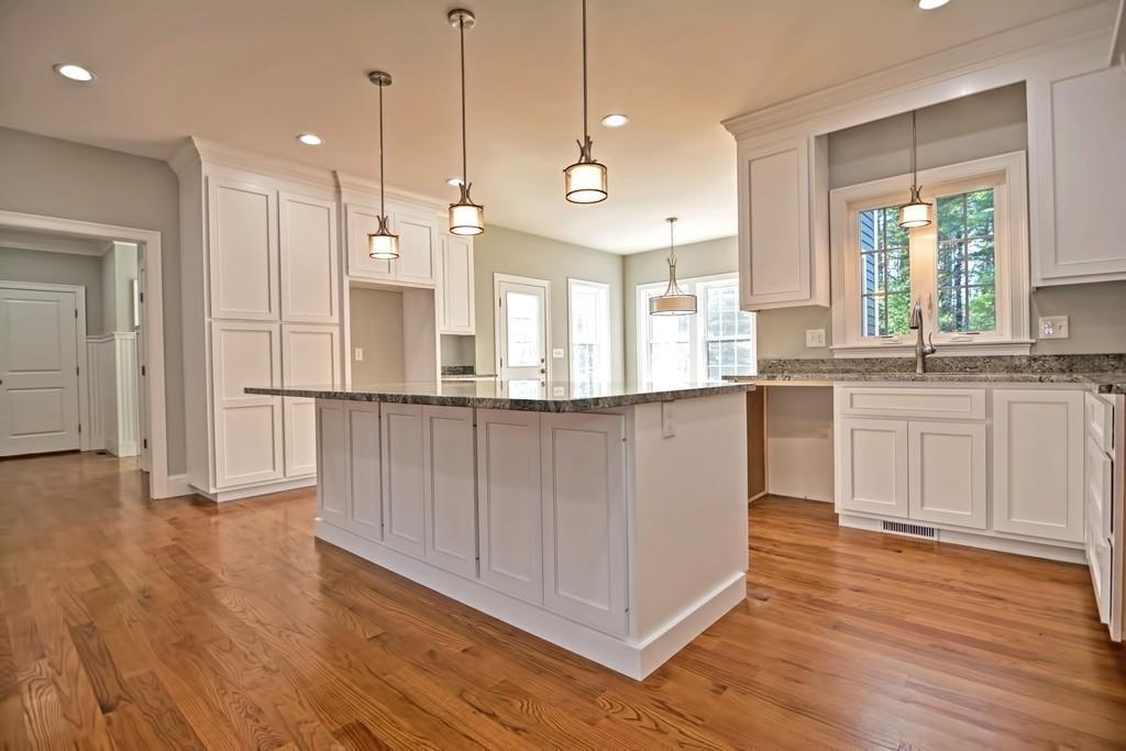 115 High Street Medfield, MA 02052 - Photo 5 of 42 a large kitchen with granite countertop a stove a sink a center island and wooden floor