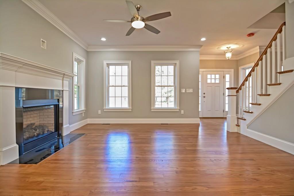 115 High Street Medfield, MA 02052 - Photo 7 of 42 an empty room with wooden floor fireplace and windows