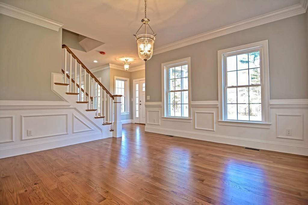 115 High Street Medfield, MA 02052 - Photo 8 of 42 a view of an empty room with wooden floor and a window