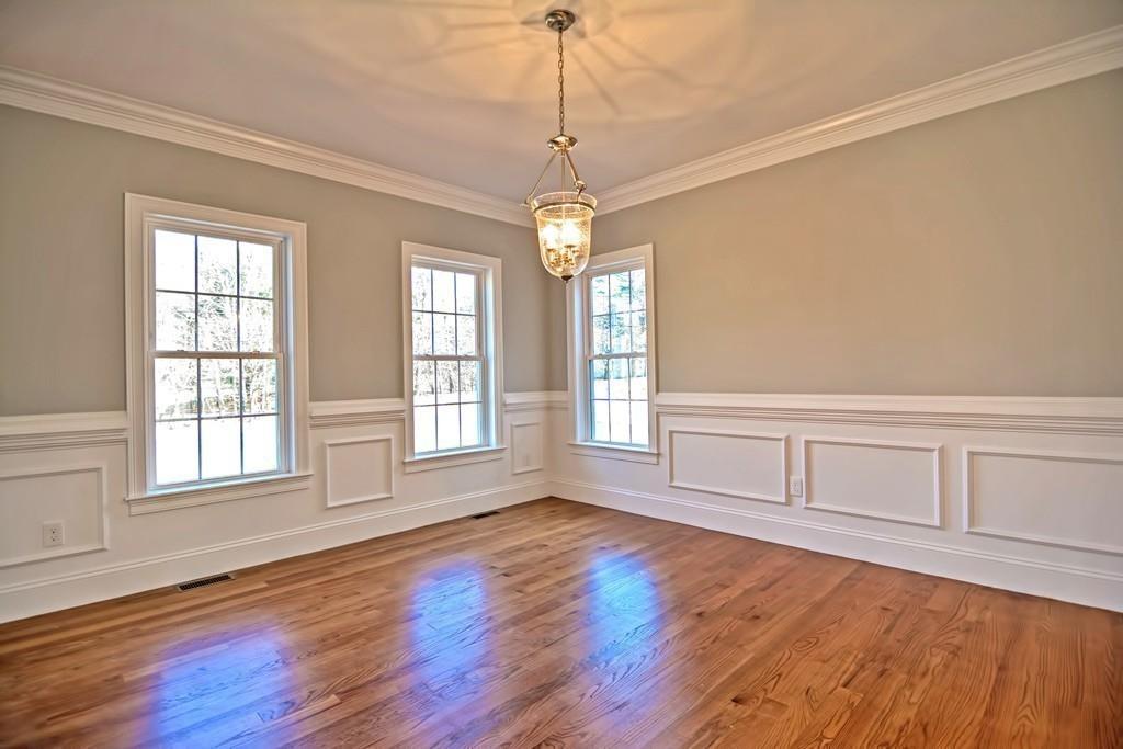 115 High Street Medfield, MA 02052 - Photo 9 of 42 a view of an empty room with wooden floor and windows