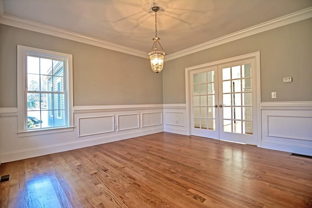 115 High Street Medfield, MA 02052 - Photo 10 of 42 a view of an empty room with wooden floor and a window