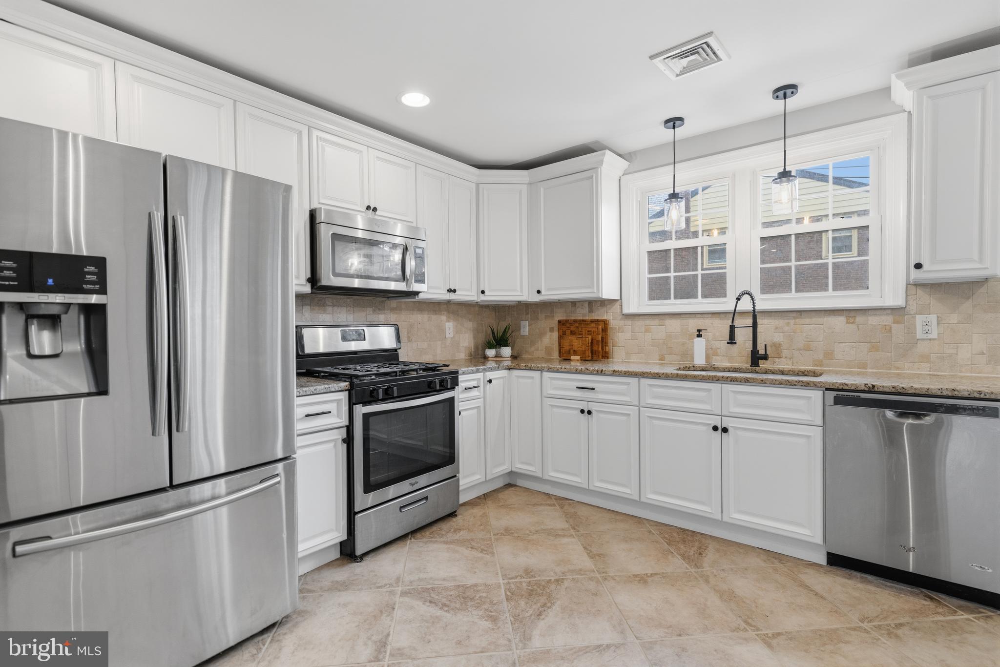 1405 Church Road Wyncote, PA 19095 - Photo 14 of 38 a kitchen with granite countertop stainless steel appliances and refrigerator