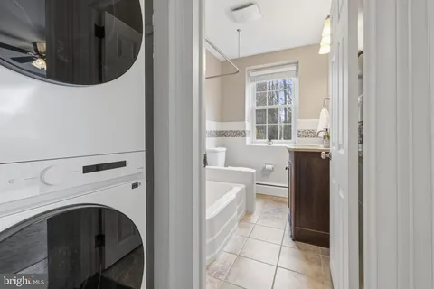 a hallway with a washer and dryer