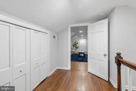 a view of a hallway view with wooden floor and staircase