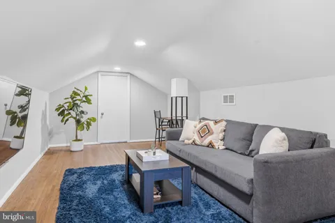 a living room with furniture and painting on the wall