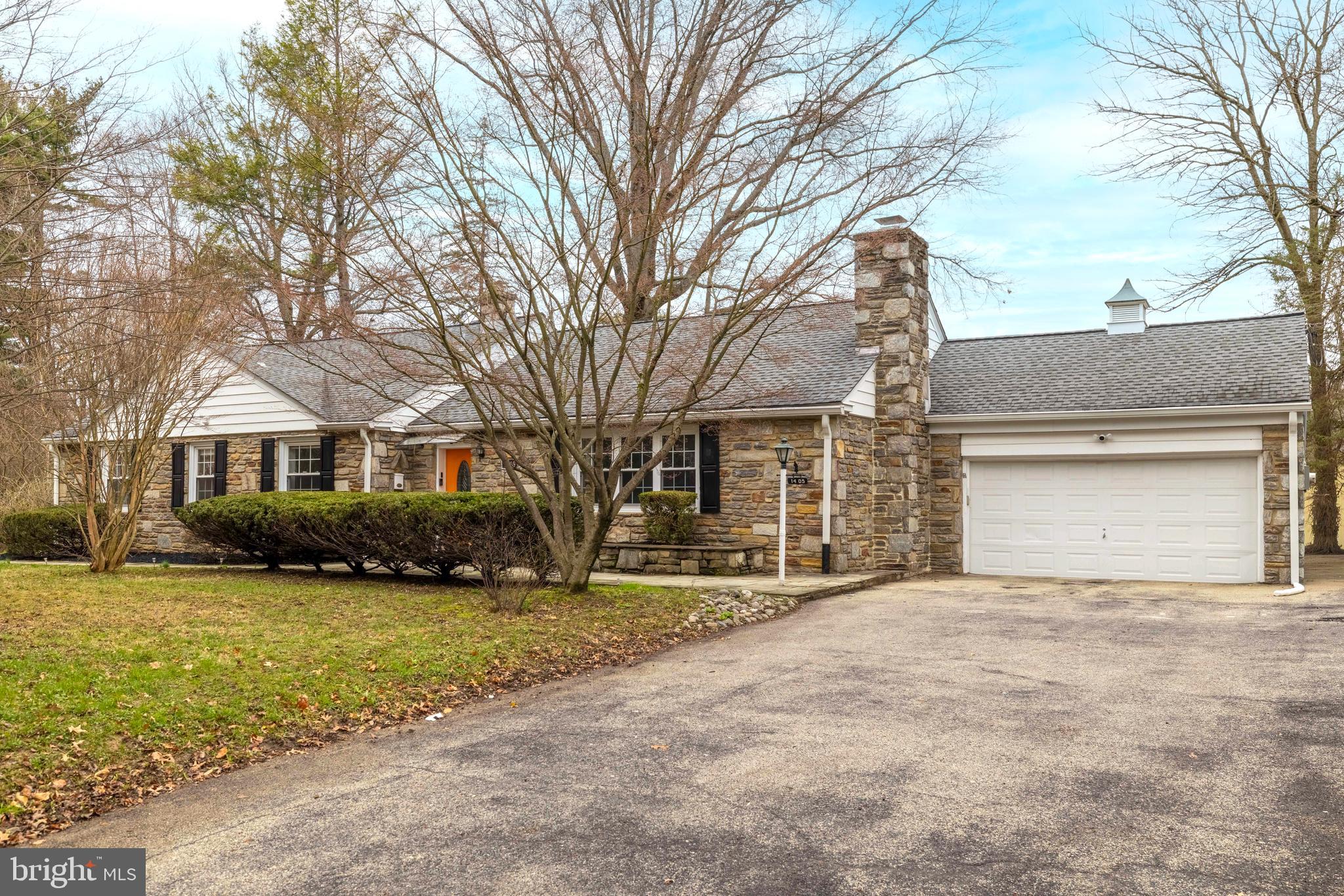 1405 Church Road Wyncote, PA 19095 - Photo 3 of 38 a front view of a house with a yard and garage