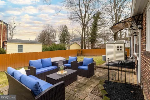 a outdoor space with patio couches and a fireplace