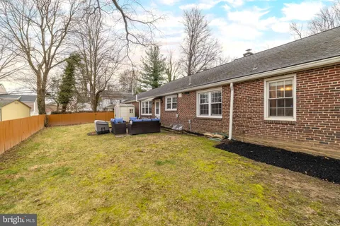 a view of a house with a yard covered in snow