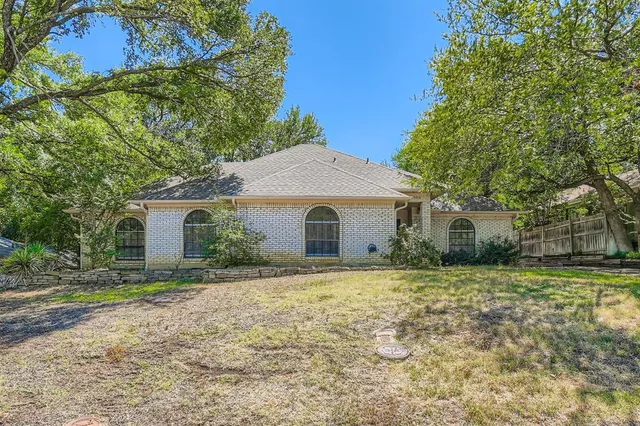 a front view of house with yard and trees