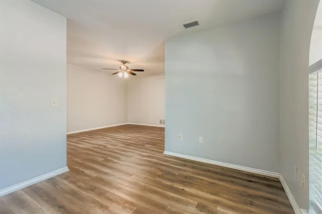 a view of a room with wooden floor