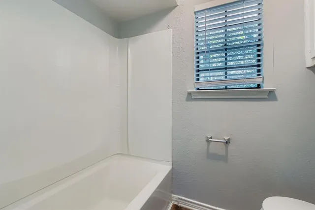 a bathroom with a bathtub and window
