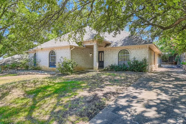 a front view of house with yard and trees