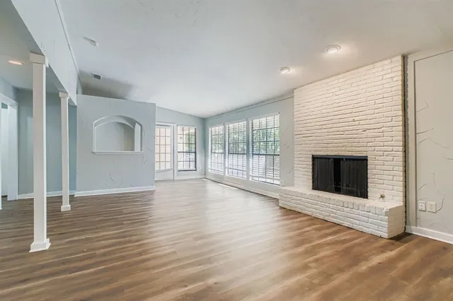 a view of a livingroom with wooden floor and fireplace