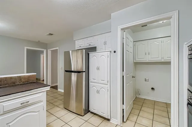 a kitchen with stainless steel appliances a refrigerator and a stove top oven