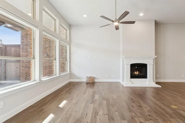 a view of an empty room with a fireplace and a window