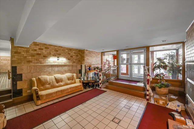 a living room with furniture and a floor to ceiling window