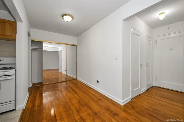 a view of a room with wooden floor
