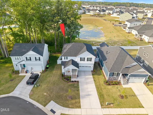 an aerial view of a house with swimming pool and ocean view