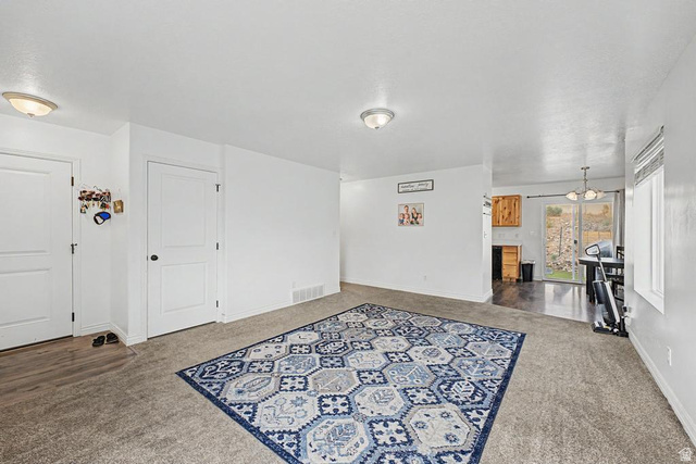 1692 South Windemere Road Santaquin, UT 84655 - Photo 4 of 23 Carpeted living area with white walls and ceiling-mounted dome lighting