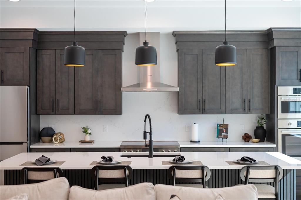 2446 Floyd Street Sarasota, FL 34239 - Photo 12 of 70 a kitchen with a refrigerator and a stove top oven
