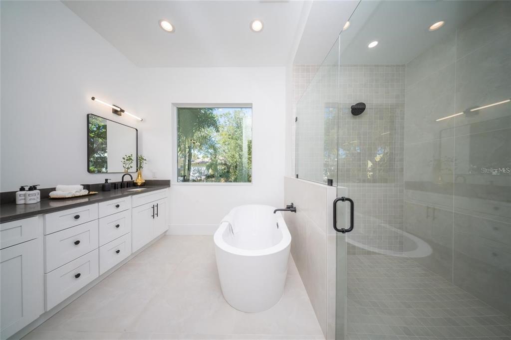 2446 Floyd Street Sarasota, FL 34239 - Photo 22 of 70 a bathroom with a double vanity sink toilet and shower