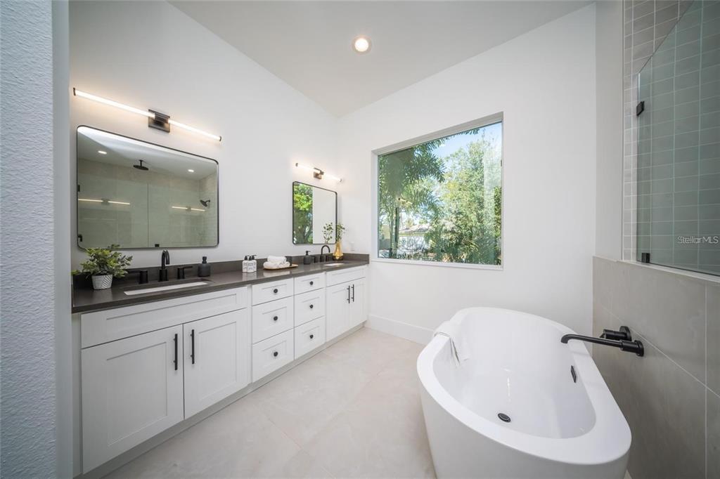 2446 Floyd Street Sarasota, FL 34239 - Photo 23 of 70 a bathroom with double vanity sink a mirror and a bathtub