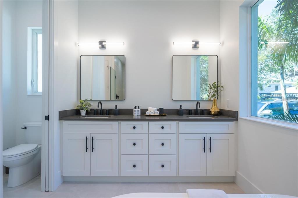 2446 Floyd Street Sarasota, FL 34239 - Photo 25 of 70 a bathroom with double sink and a mirror