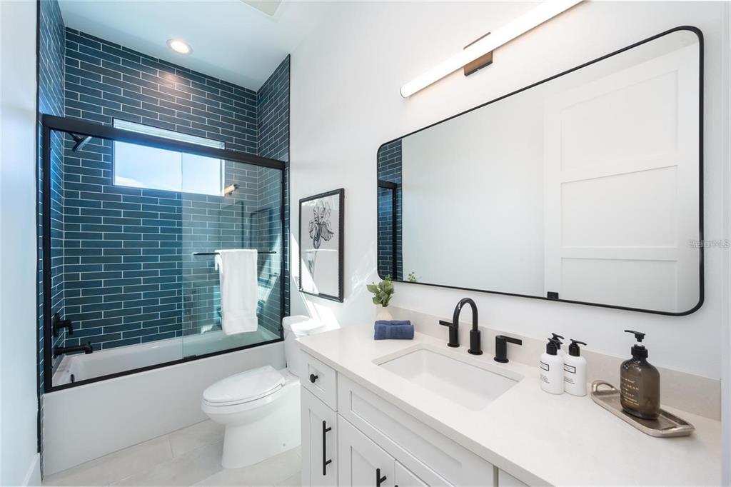 2446 Floyd Street Sarasota, FL 34239 - Photo 39 of 70 a bathroom with a sink a toilet and shower
