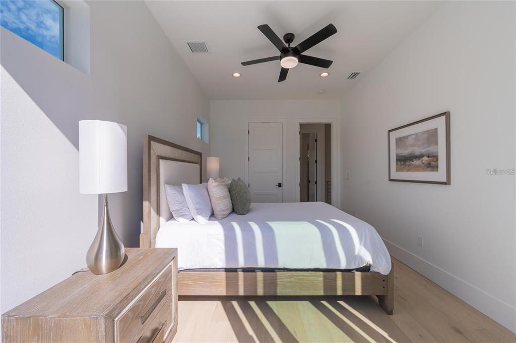 2446 Floyd Street Sarasota, FL 34239 - Photo 46 of 70 a bedroom with a large bed and a chandelier