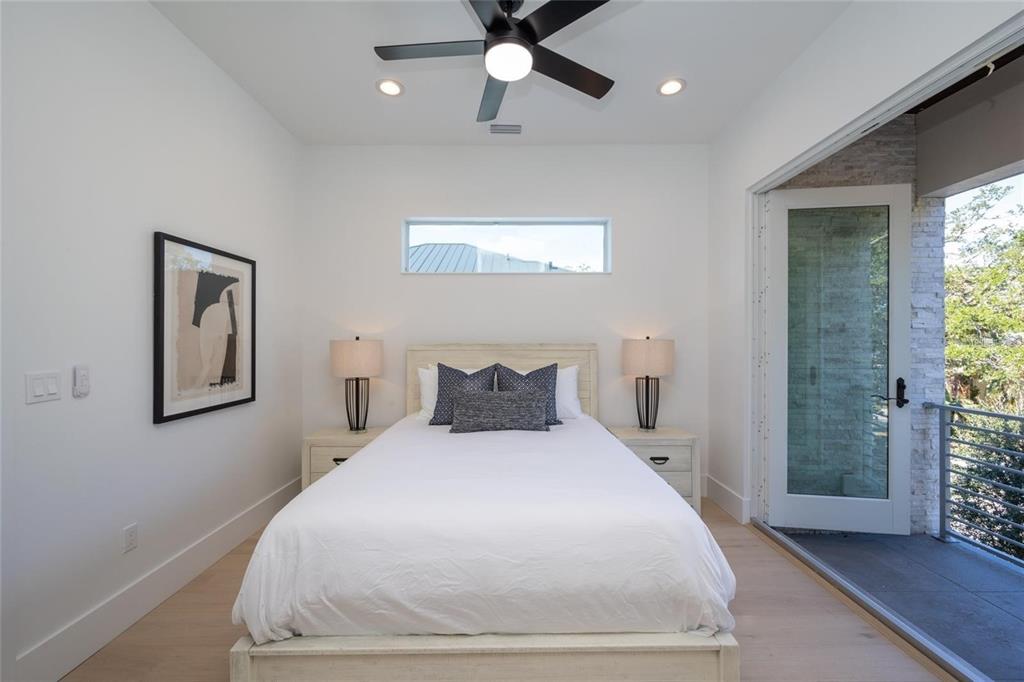 2446 Floyd Street Sarasota, FL 34239 - Photo 53 of 70 a bedroom with a large bed and a chandelier