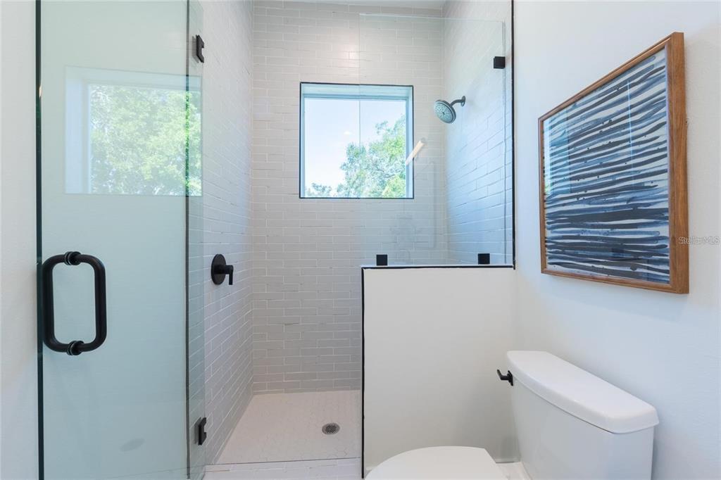2446 Floyd Street Sarasota, FL 34239 - Photo 57 of 70 a bathroom with a shower toilet and a window