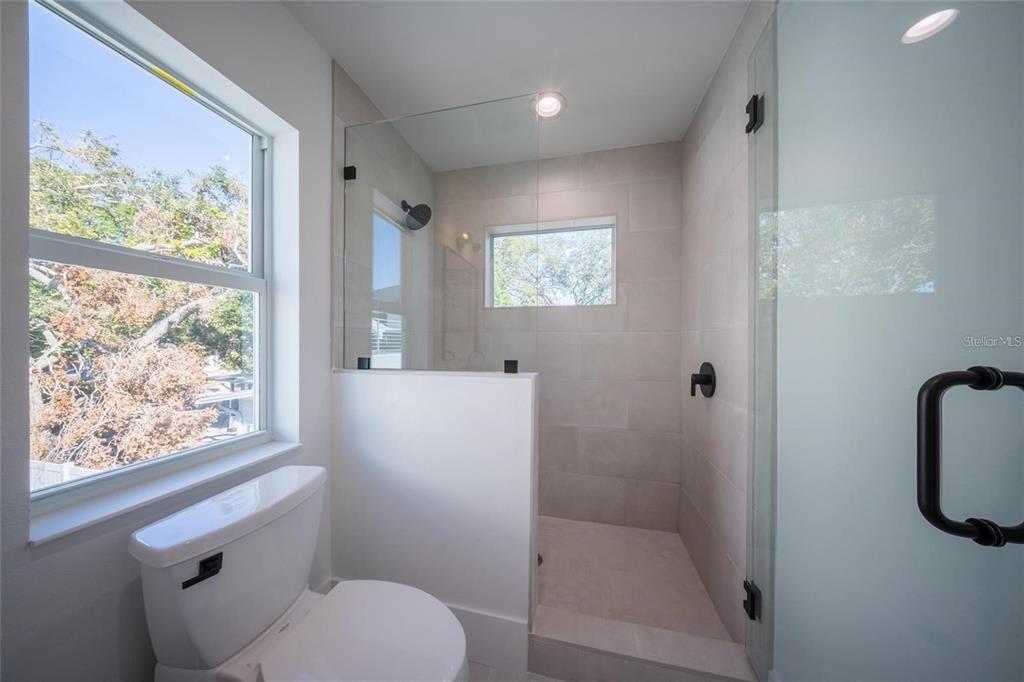 2446 Floyd Street Sarasota, FL 34239 - Photo 69 of 70 a bathroom with a toilet a sink and a window