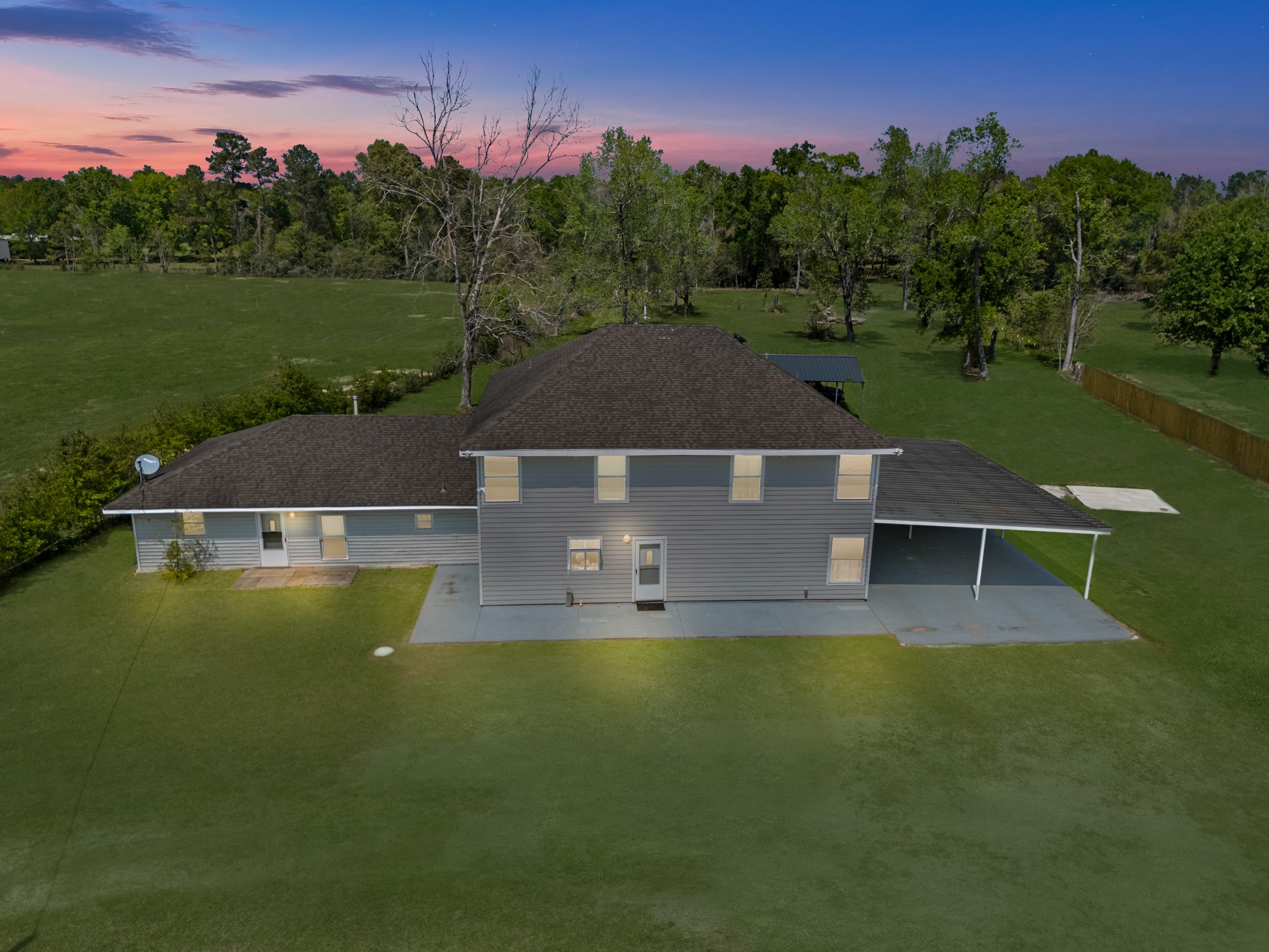 a aerial view of a house with swimming pool and a yard