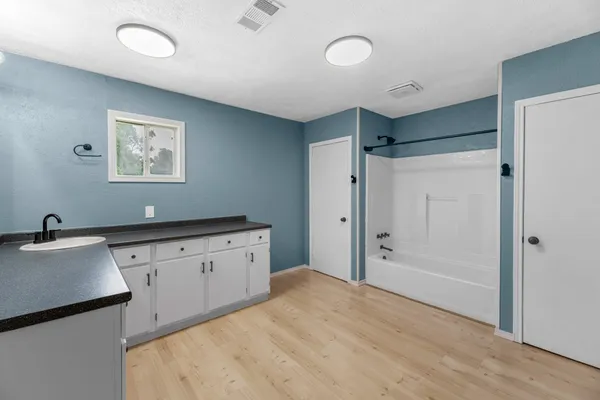 a view of a livingroom with a ceiling fan and window