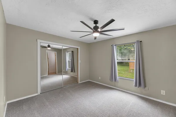 a view of a livingroom with a ceiling fan and a ceiling fan