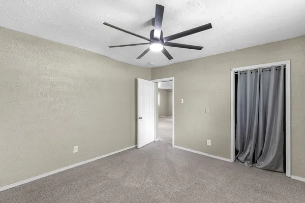 a bathroom with a toilet sink vanity and granite