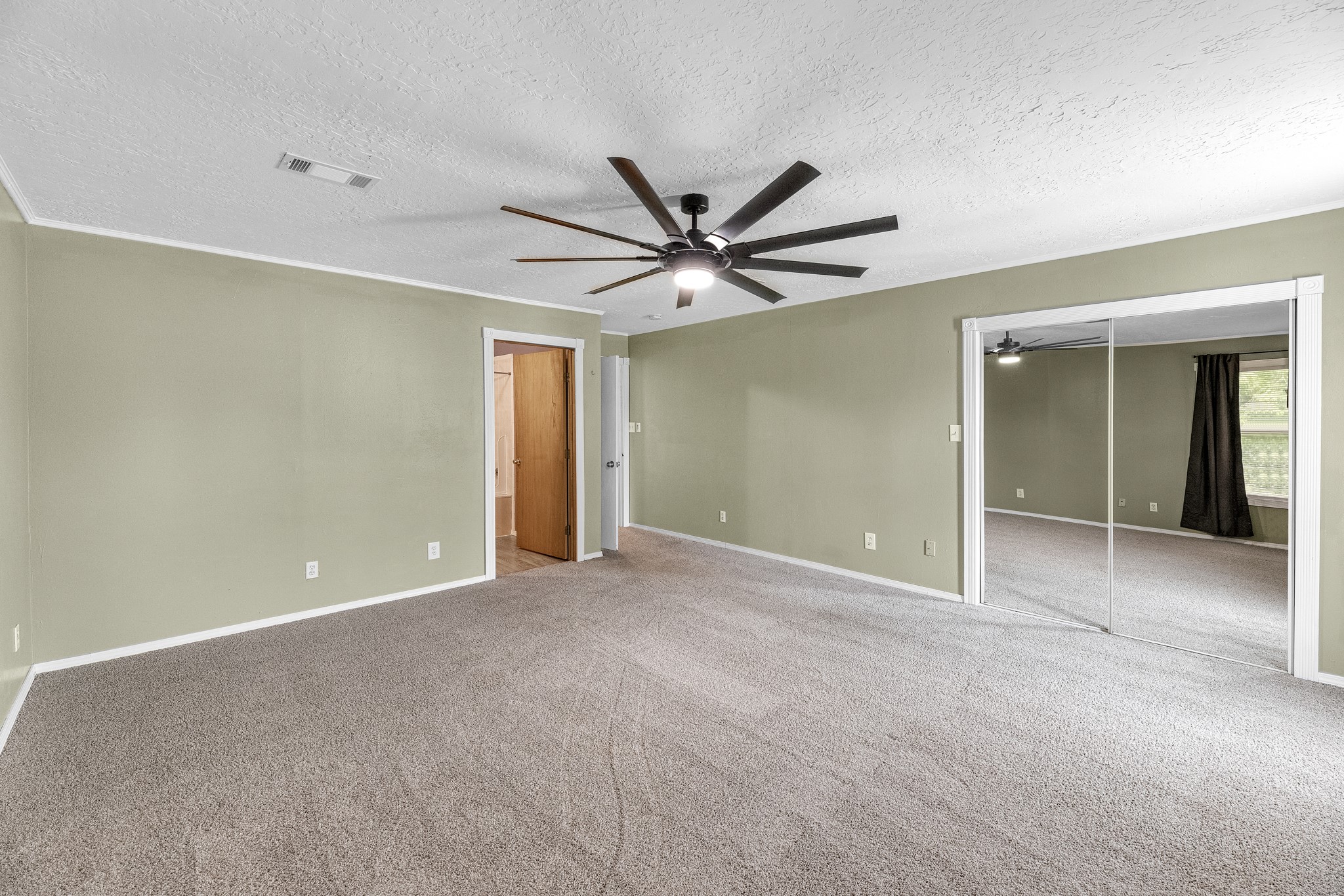 16511 Edgefield Lane Conroe, TX 77302 - Photo 3 of 42 a view of an empty room with a ceiling fan