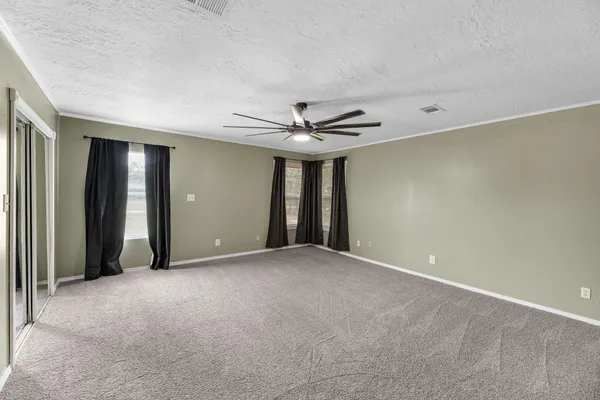 a view of an empty room with a ceiling fan